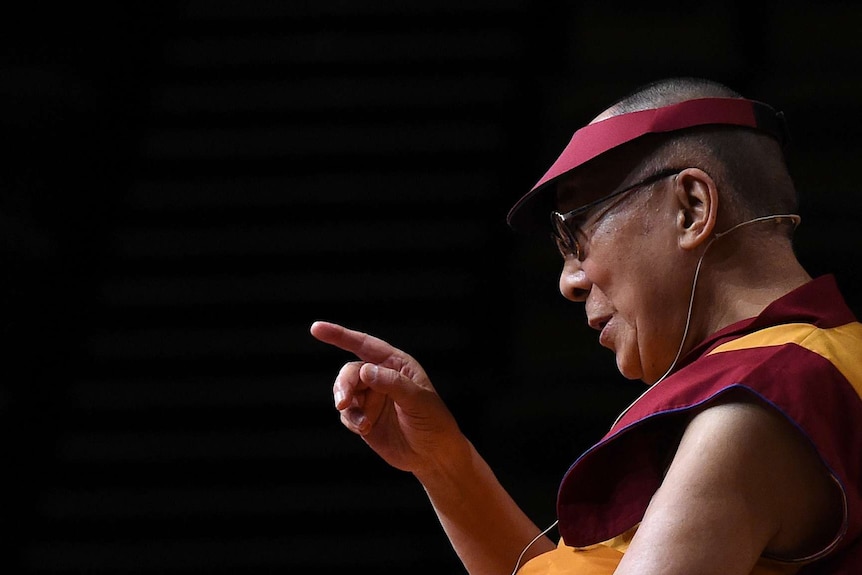 The Dalai Lama gestures during a teaching session in Brisbane
