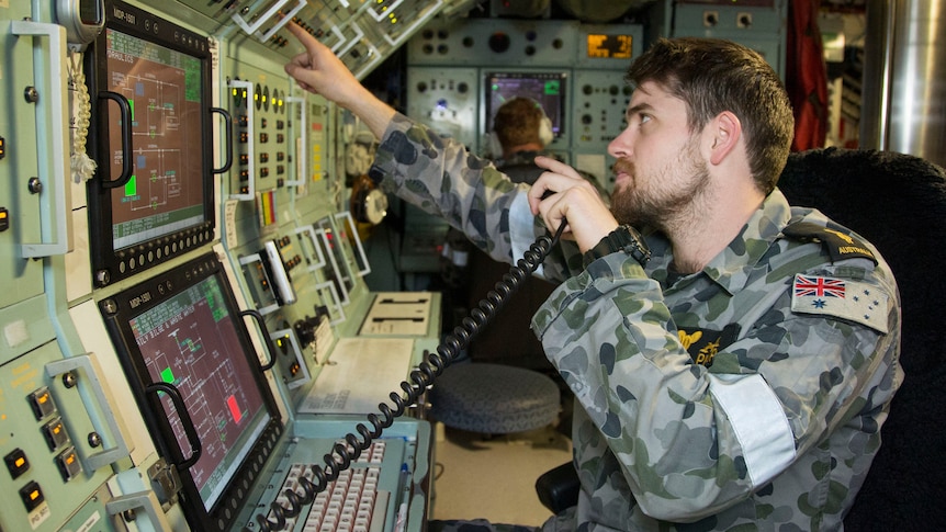 Able Seaman Marine Technician Submarines Samuel Pickup mans the dive safety console on board HMAS Sheean.