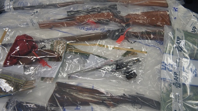 The guns were seized during simultaneous raids in Canberra's south.