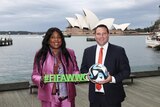 Two soccer administrators pose for a photo outside the Sydney Opera House
