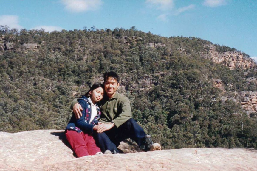 Archival image of a man and his daughter in the Australian bush.