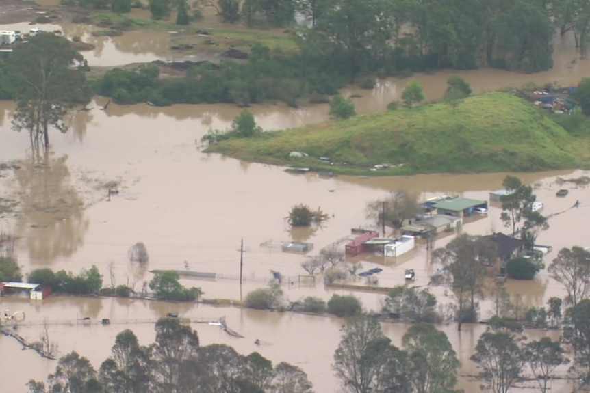 An aerial shot of a badly flooded semi-rural area.