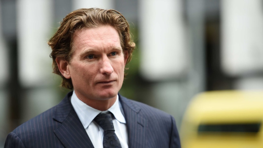 James Hird wearing a suit and tie leaves the Supreme Court.