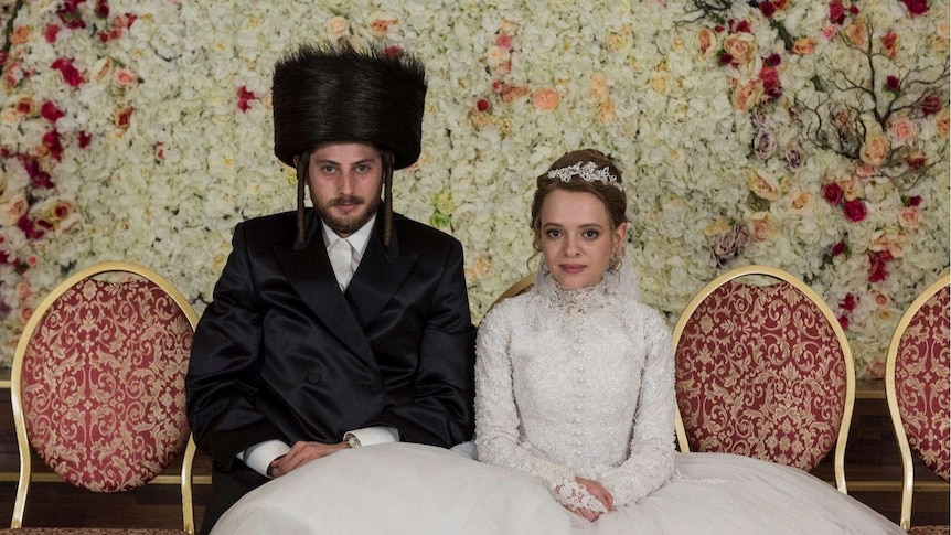 A still from Netflix's Unorthodox with the actors Amit Rahav and Shira Haas playing Orthodox Jewish people on their wedding day