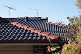 a black roof on a suburban home