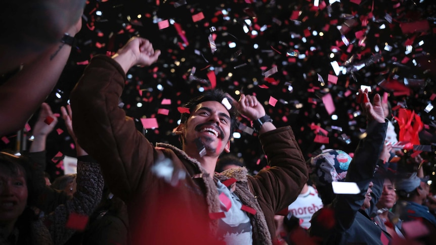 Smiling and waving supporters of presidential candidate Andres Manuel Lopez Obrador celebrate his victory in Mexico City.