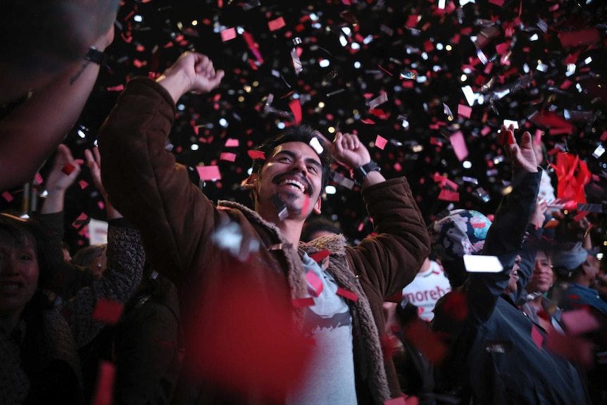 Smiling and waving supporters of presidential candidate Andres Manuel Lopez Obrador celebrate his victory in Mexico City.