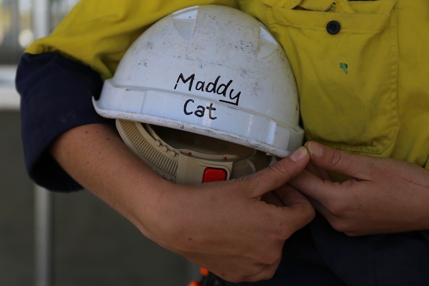 Hard hat that says 'Maddy Cat'