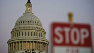 A stop sign is seen next to US Congress building - custom size 320x180