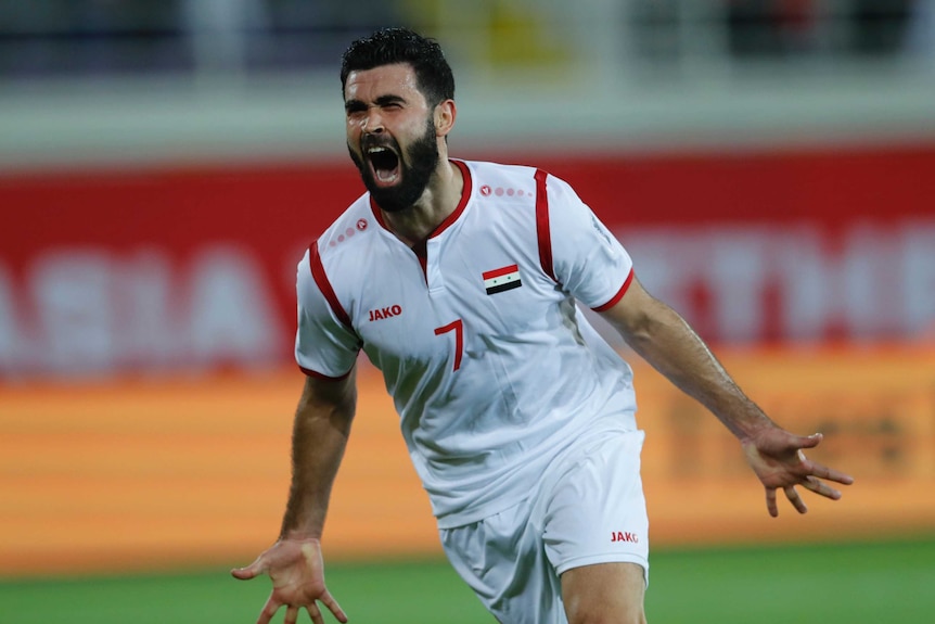 Omar Khrbin celebrates scoring against Australia