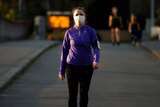 A woman exercising with a mask on in Melbourne.