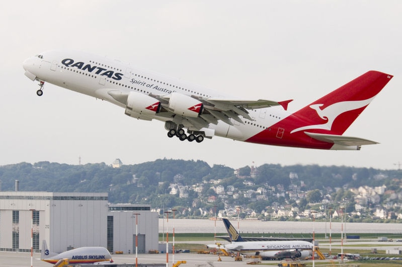 Qantas aircraft taking off from an airport.