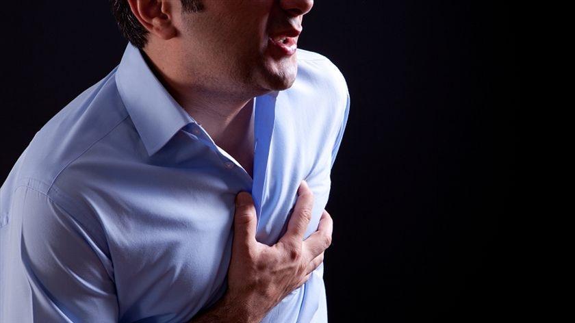 Man feels heartache suffering from cardio ailments and clutching