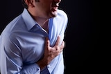 Man clutching at his chest