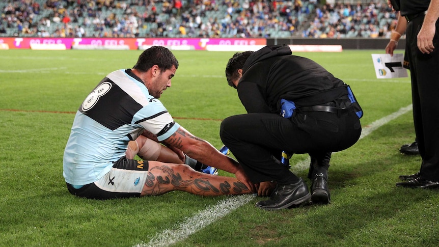 Cronulla's Andrew Fifita receives attention after injuring his ankle against Parramatta