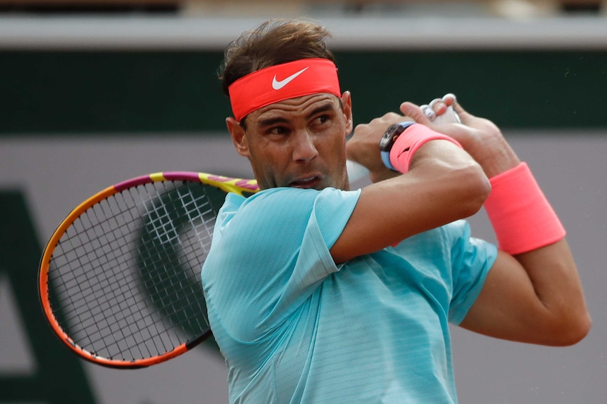 Rafael Nadal completes his backhand swing at the French Open.