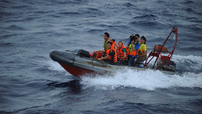 Journalists transfer to Vietnamese coastguard ship on South China Sea