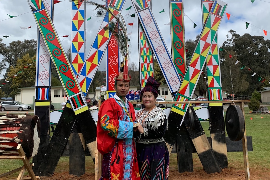 A man and woman dressed in bright colourful outfits of the Kachin community.