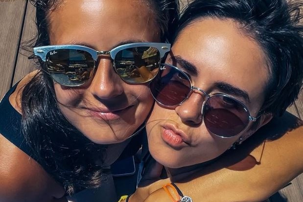 Daria Kasatkina and Natalia Zabiiako hug and mug for the camera while wearing sunglasses.