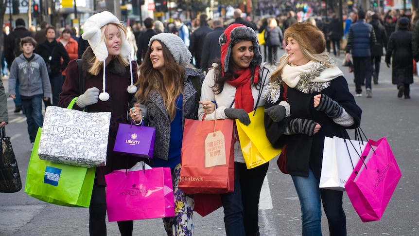 Shoppers walk down Oxford Street, London
