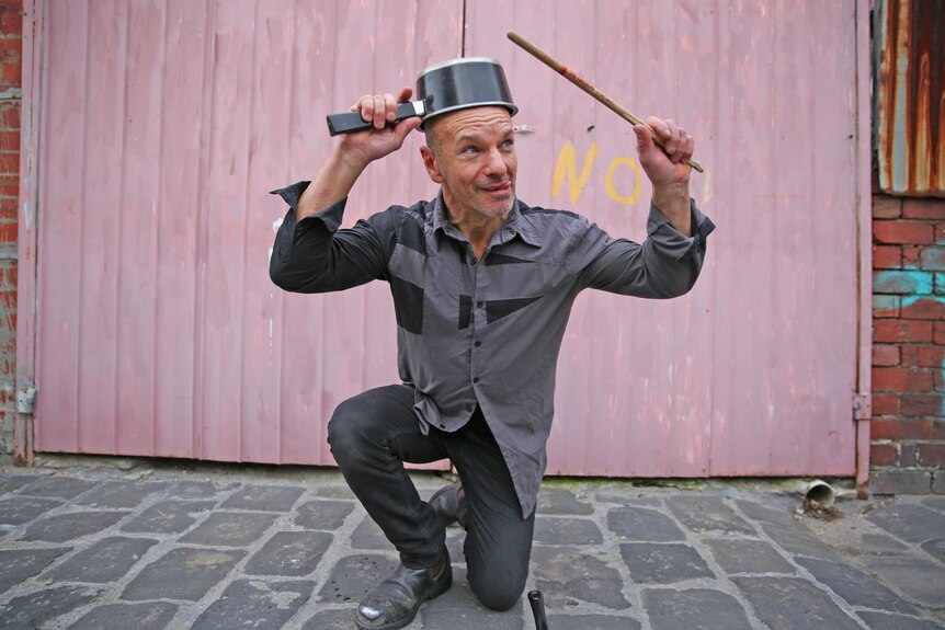 Melbourne busker Paul Guseli with a pot on his head
