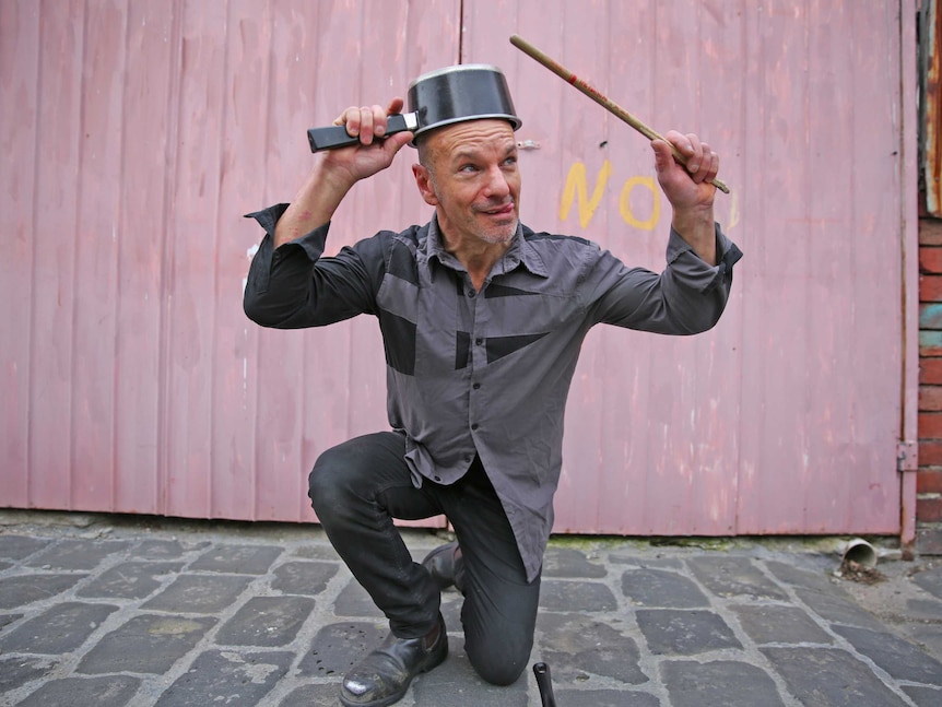 Melbourne busker Paul Guseli with a pot on his head