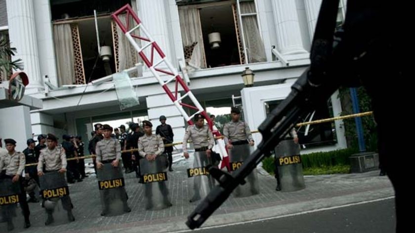 Indonesian Police stand in front of the Ritz Carlton hotel in Jakarta