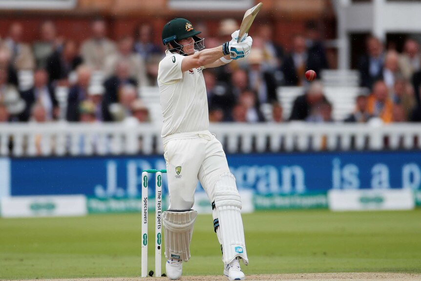 Steve Smith rolls his wrists over a short ball with a pull shot in front of the Lord's pavillion.