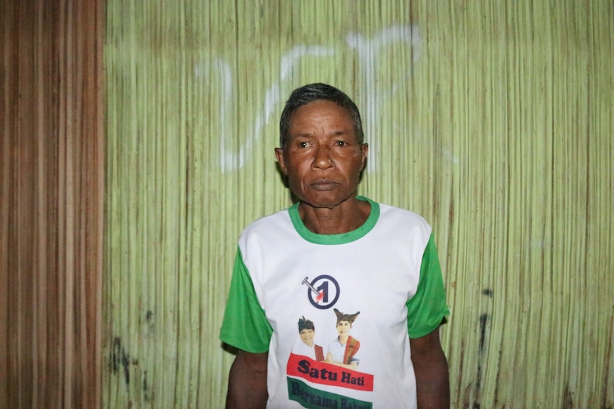 Celestino De Andrade poses for a photo with a serious expression on his face.