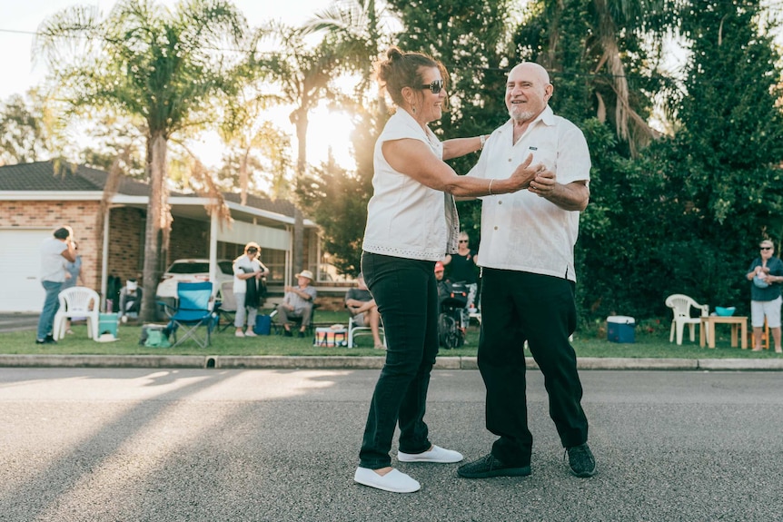 Tony Borg and Irene Taylor of the Kava Malt Duo dance in the street, holding hands