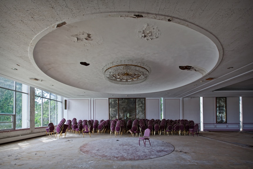 Stacks of chairs line an empty ballroom at the abandoned Fallside Hotel and Conference Centre in Niagara Falls