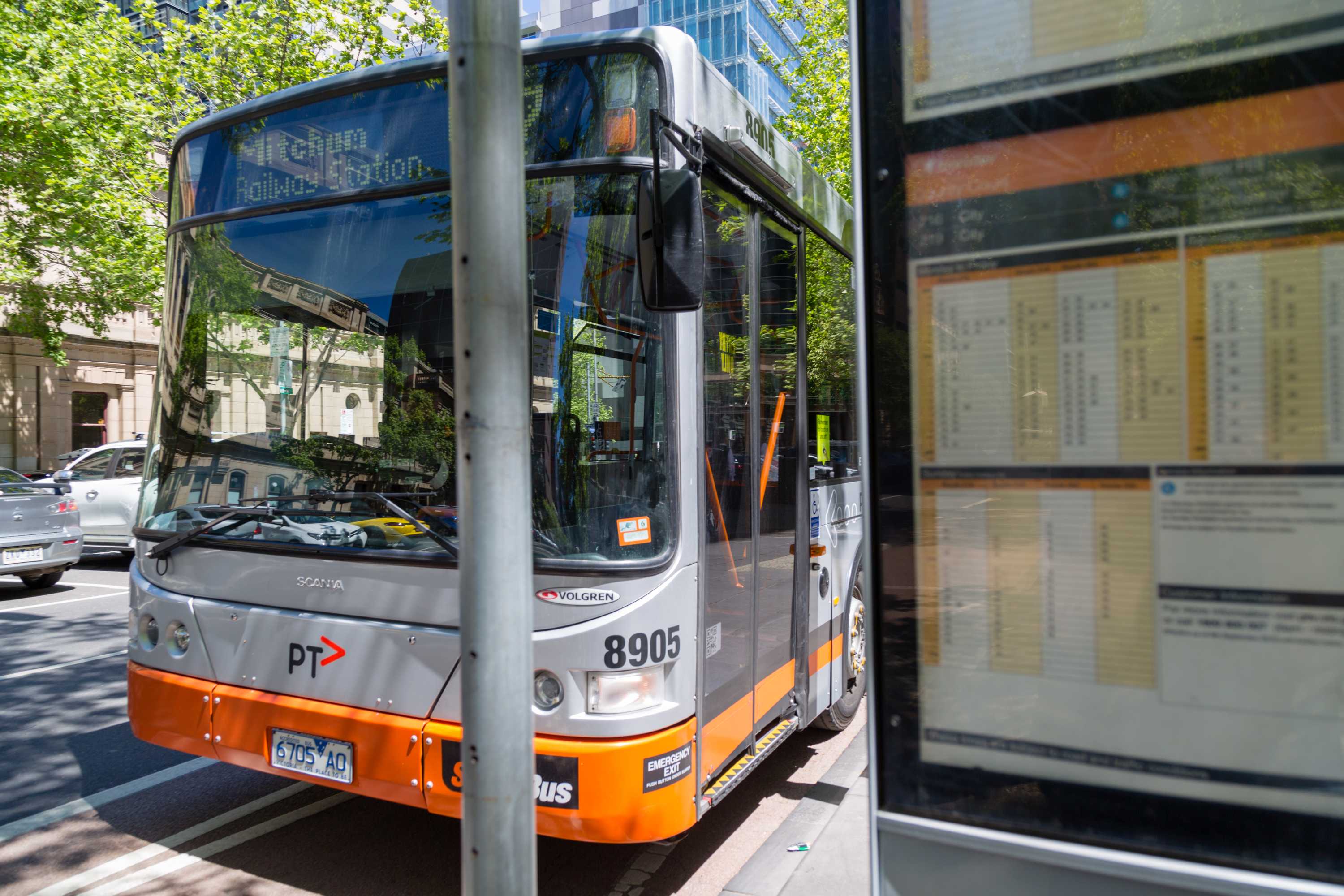 A stationary bus at a bus stop in Melbourne.
