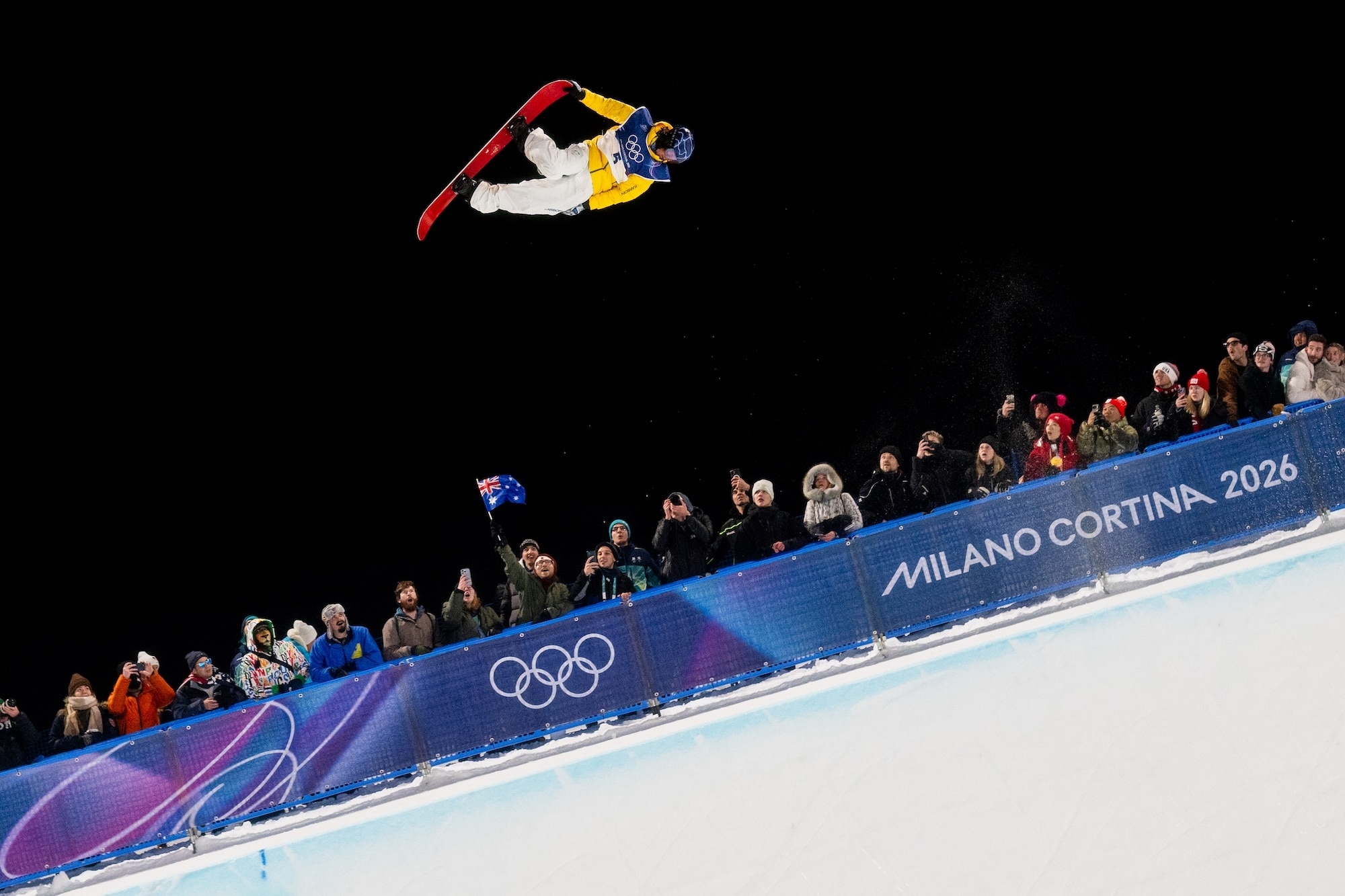 Valentino Guseli with a man flying an Australia flag