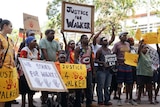 Protesters hold 'Justice for Walker' placards at a protest in Darwin's CBD.