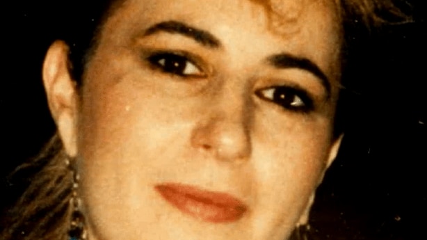 A close up photo of a young woman smiling.