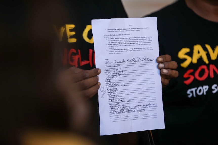 A man's hands holding a letter