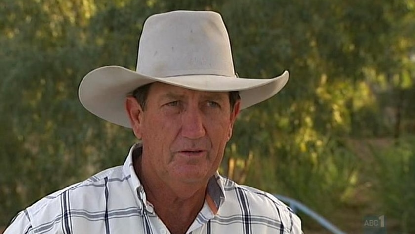 A man in a broad brimmed hat and checked shirt 