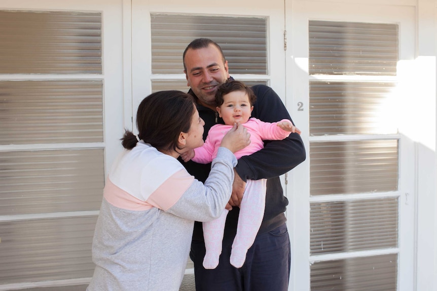 Mano, Hasmig and Nairi stand outside their house