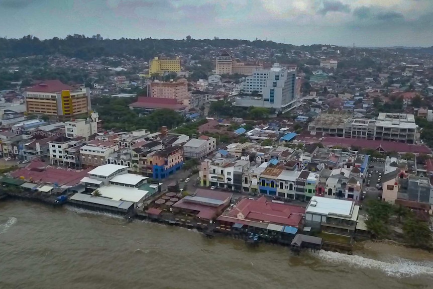 A drone shot of a beach side city in Indonesia