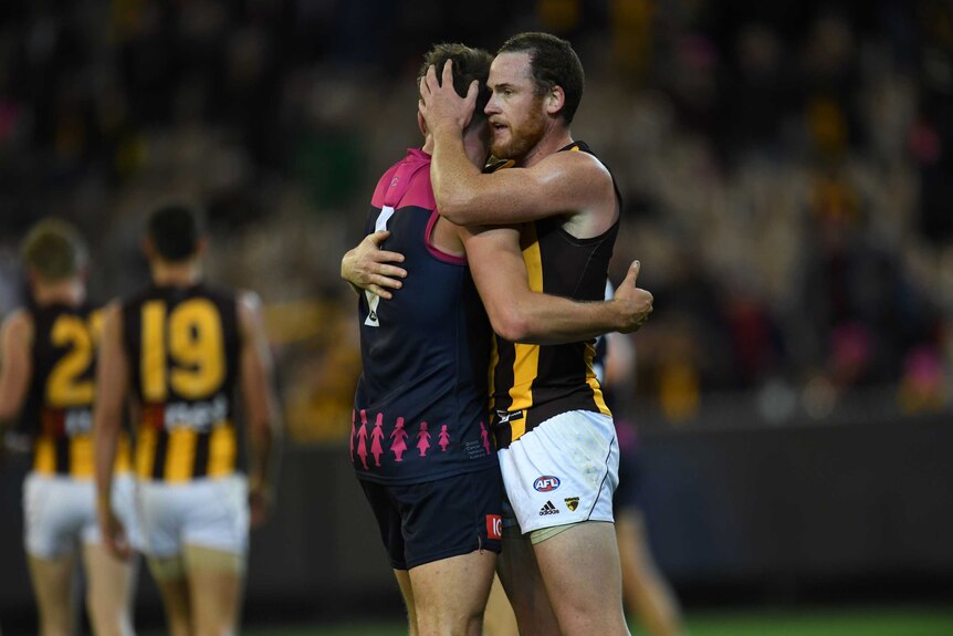 Jesse Hogan (left) embraces Jarryd Roughead on the MCG after playing against each other.