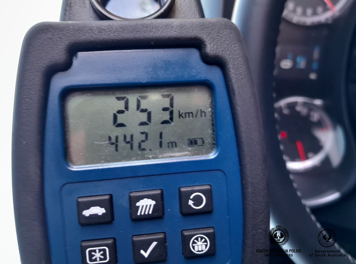 A speed gun showing 253 kilometres per hour.