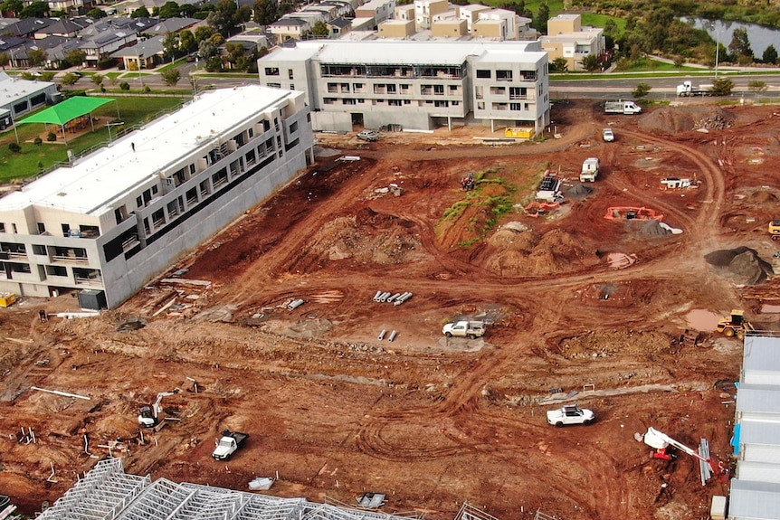 A drone image of construction happening in a large plot of land.