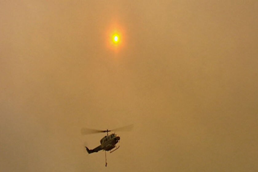 Three water bombing helicopters have been used to try to contain the Bellingham fire (file photo)