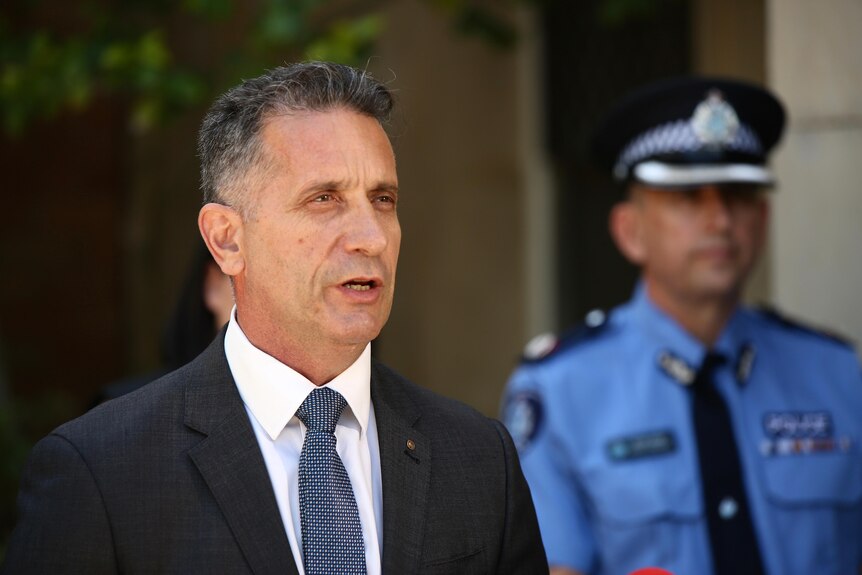 Paul Papalia speaking at a press conference wearing a dark coloured blazer and white shirt