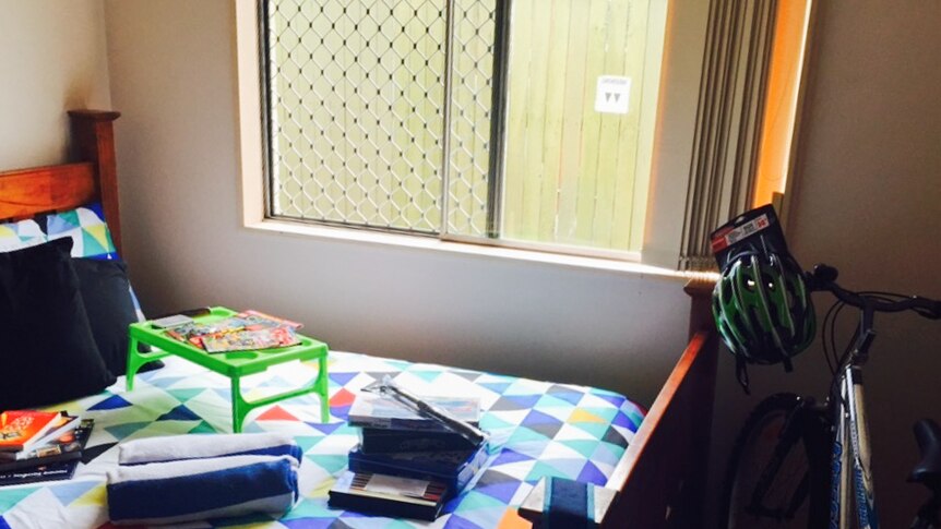 A young boy's bedroom set up by the RizeUp team equipped with bedding, books, toys and a new bike.