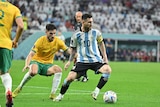A Socceroos player tries to shut down Argentina's Lionel Messi on the ball during a World Cup game.
