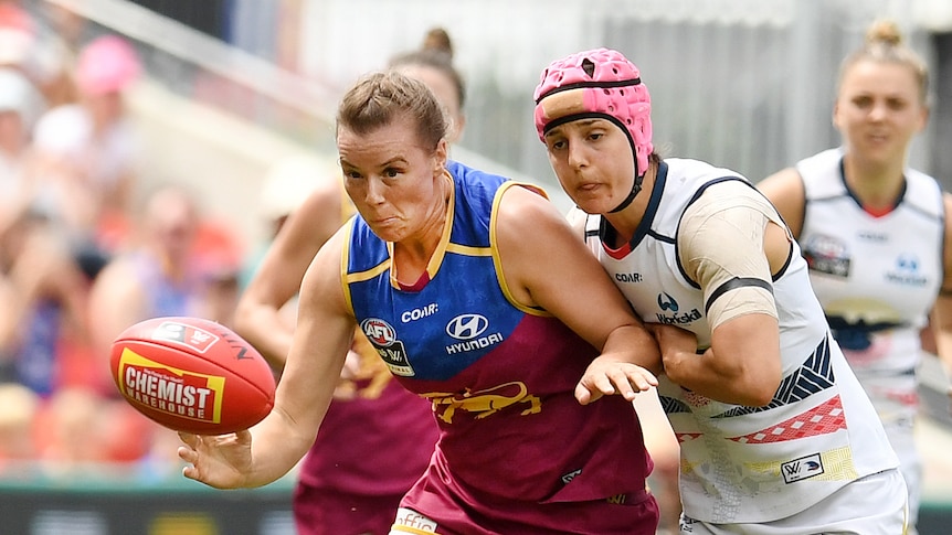 Brittany Gibson and Heather Anderson compete for the ball in an AFL game.
