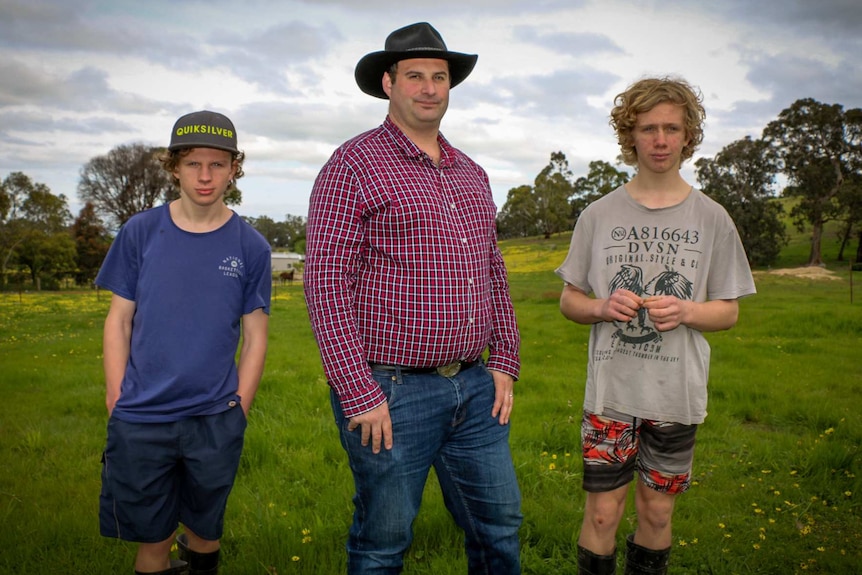Ron D'Arcy (centre) with his two sons on their property in Toongabbie.