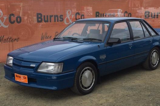 A 1985 VK HDT Commodore Group A Brock Edition SS in dark blue.