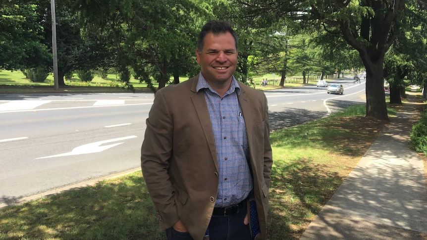 Philip Donato standing in front of trees.